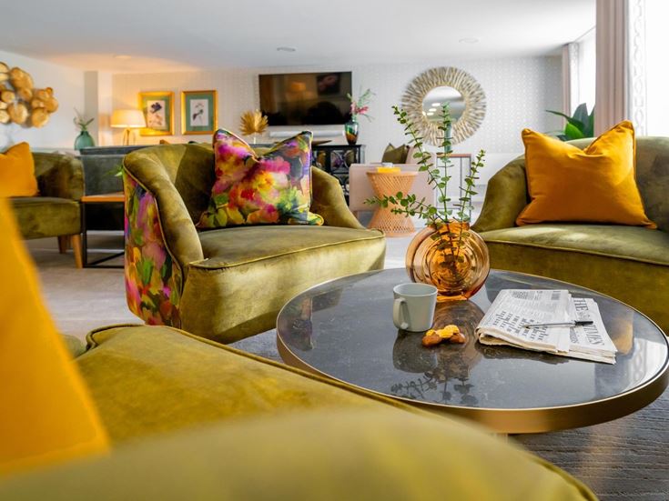 a living room with a coffee table and couches
