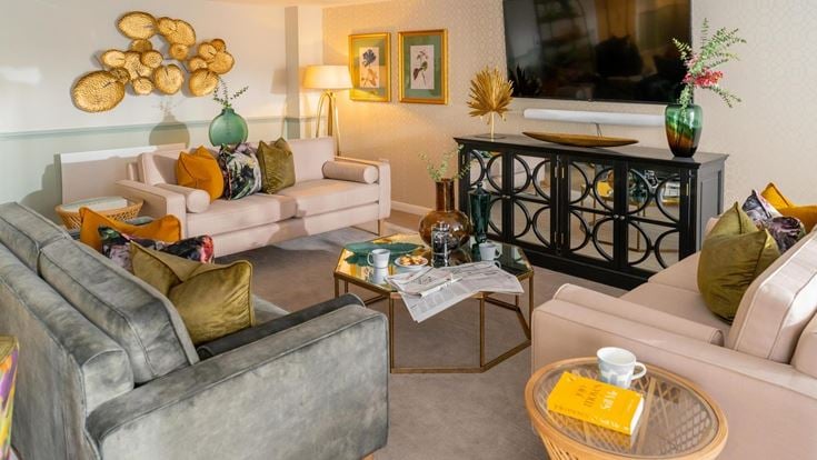 a living room with a tv and couches