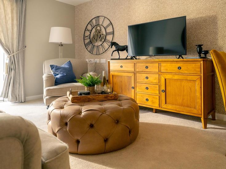 a living room with a tv and furniture