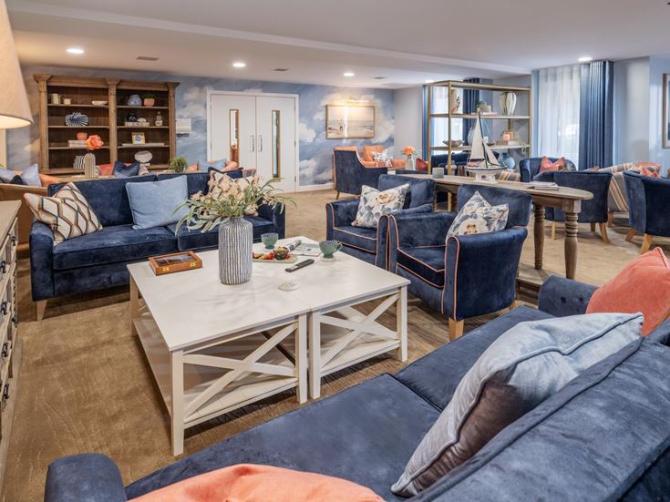 a living room with blue couches