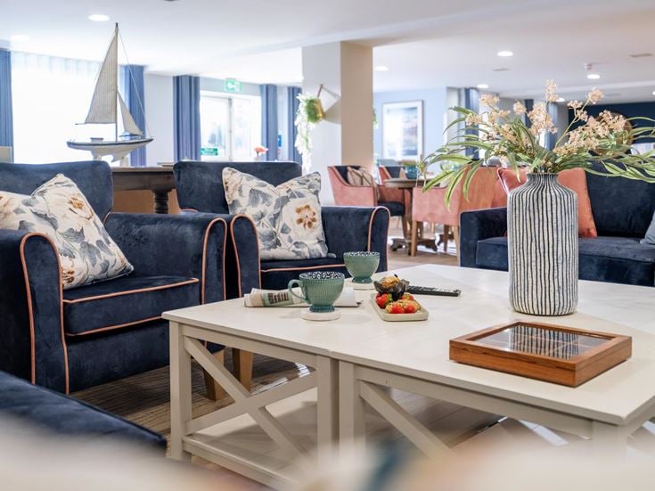 a living room with a large glass table and couches