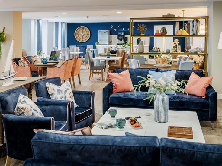 a living room with blue couches