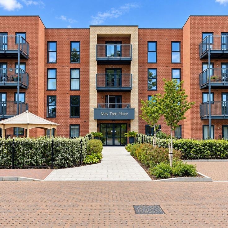 a building with a walkway and trees