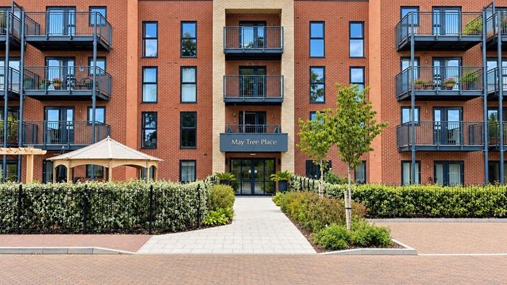 a building with a walkway and trees