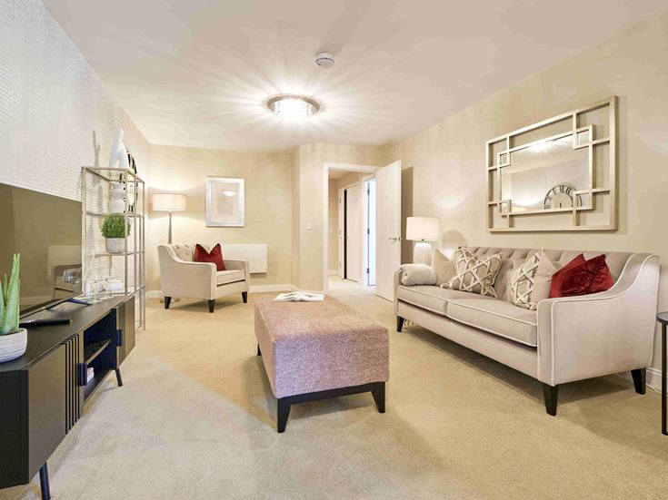 a living room with a white couch and a pink table