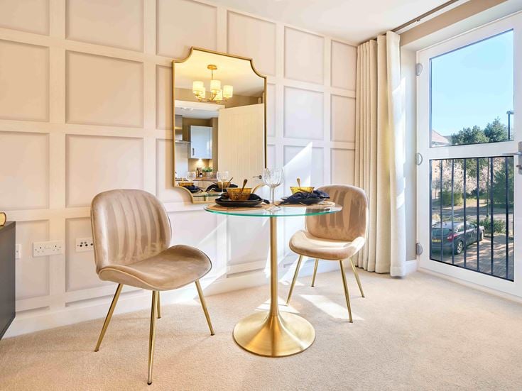 a dining room with a table and chairs