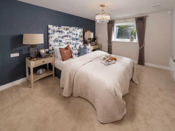a bedroom with a bed and a lamp
