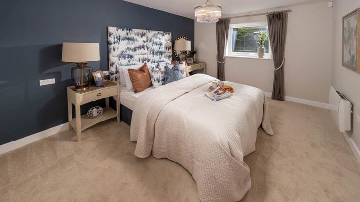 a bedroom with a bed and a lamp