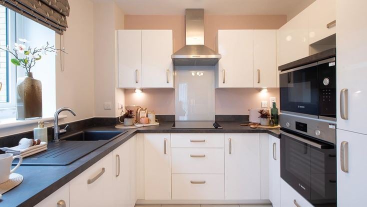 a kitchen with white cabinets