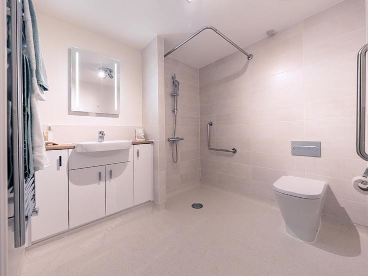 a bathroom with a shower unit and sink