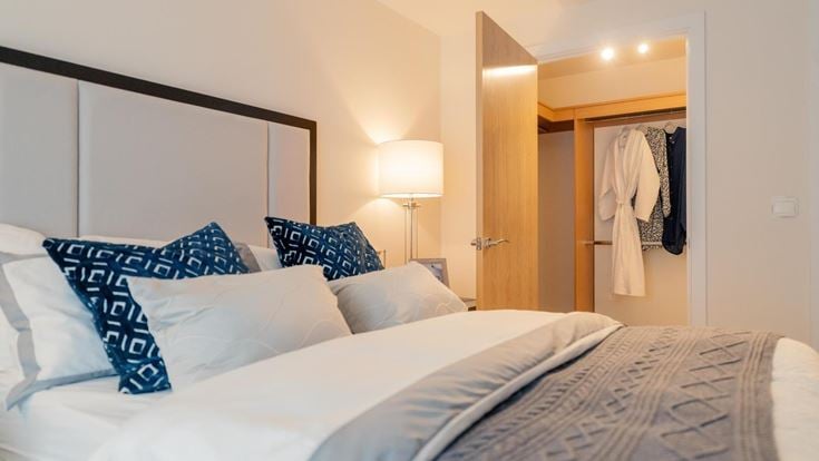a hotel room with a bed and a lamp