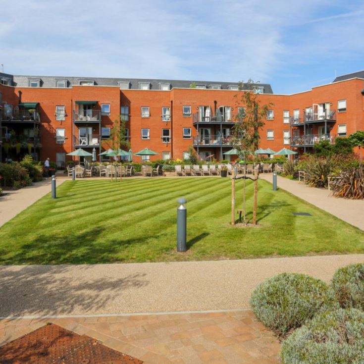 a building with a lawn and a walkway in front of it