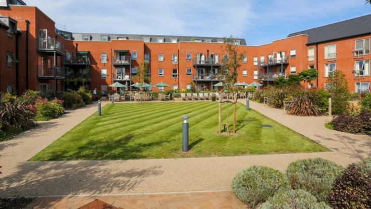 a building with a lawn and a walkway in front of it