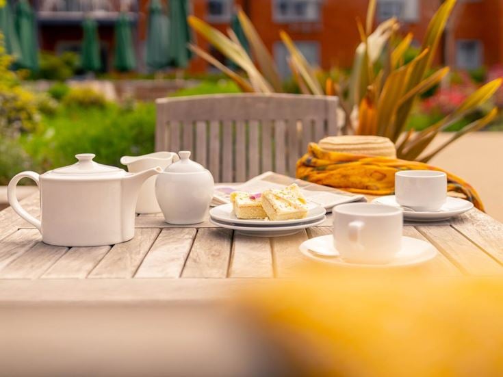 a table with plates of food and cups on it