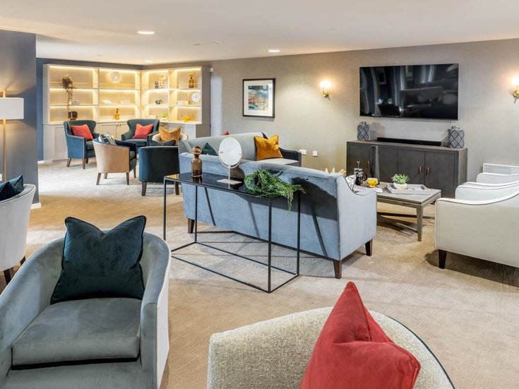 a living room with a large glass table and chairs