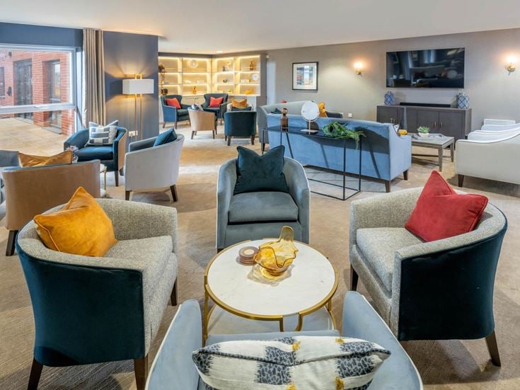 a room with a couch and chairs