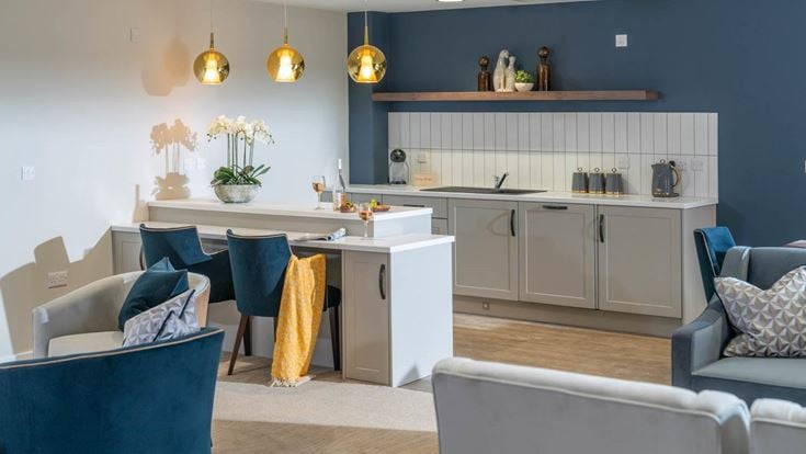 a kitchen with a bar and chairs