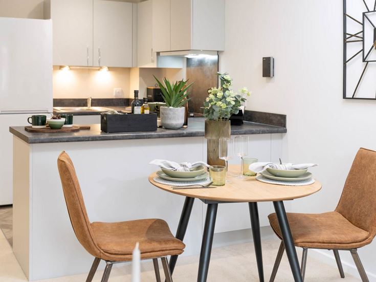 a kitchen with a table and chairs