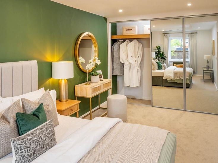 a bedroom with a large mirror