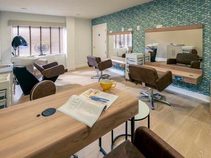 a living room with a table and chairs