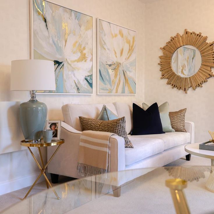 a living room with a white couch and a white table