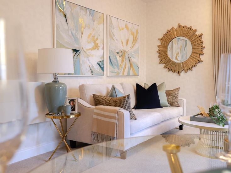 a living room with a white couch and a white table