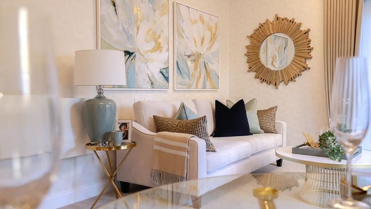 a living room with a white couch and a white table