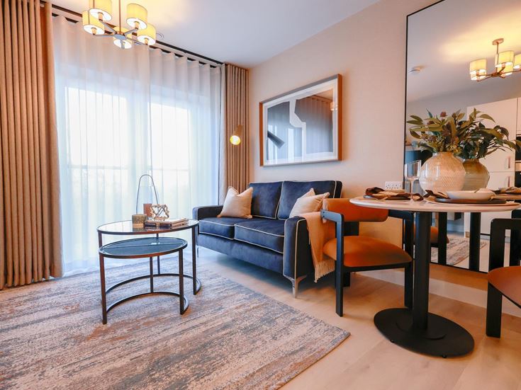 a living room with a blue couch and a table