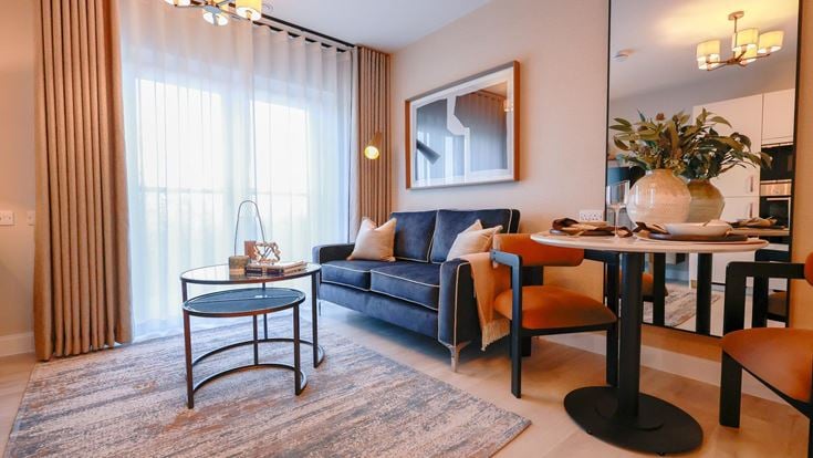 a living room with a blue couch and a table