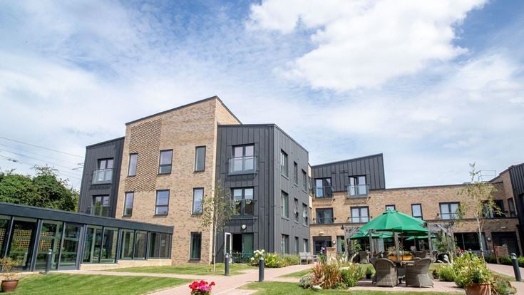 a building with a courtyard and a patio with a table and chairs