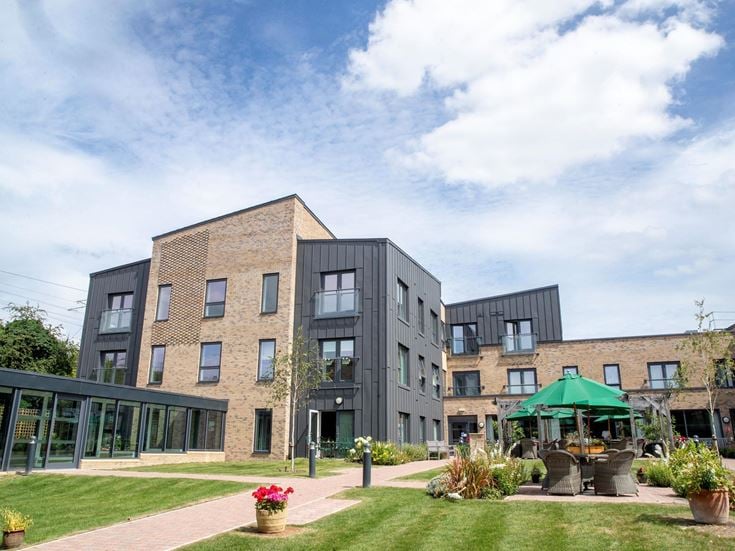 a building with a courtyard and a patio with a table and chairs