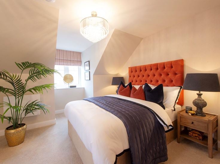 a bedroom with a bed and lamps