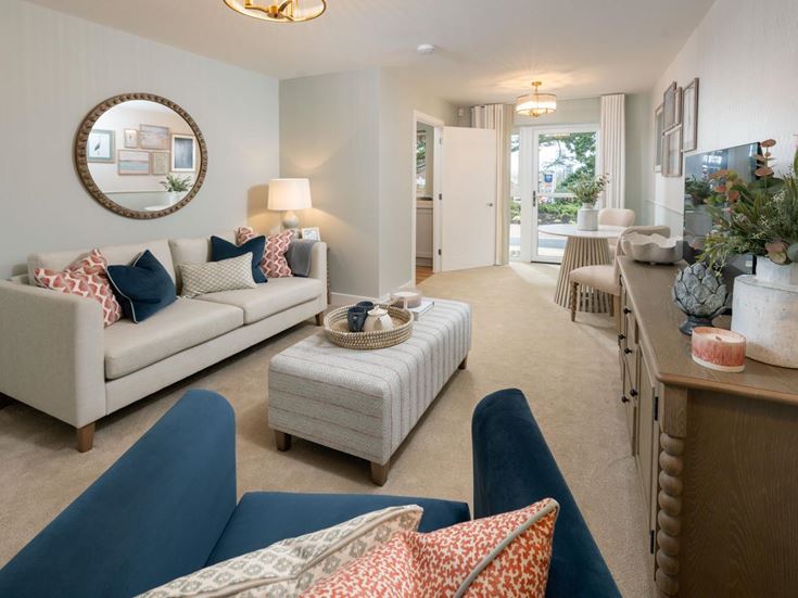a living room with a couch and chairs