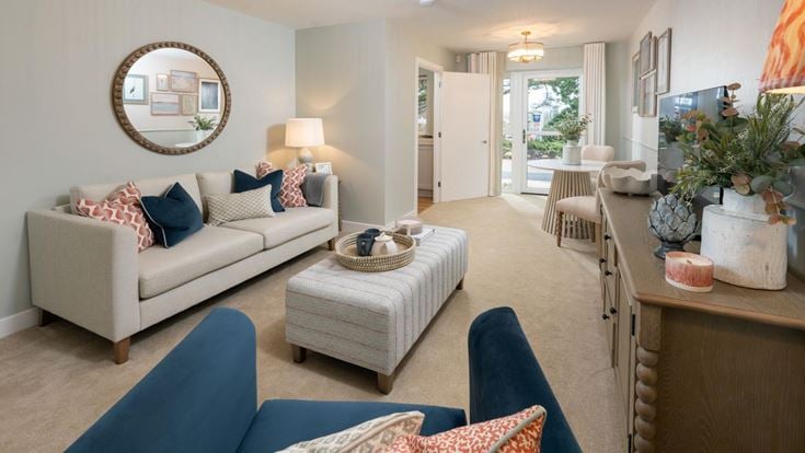 a living room with a couch and chairs