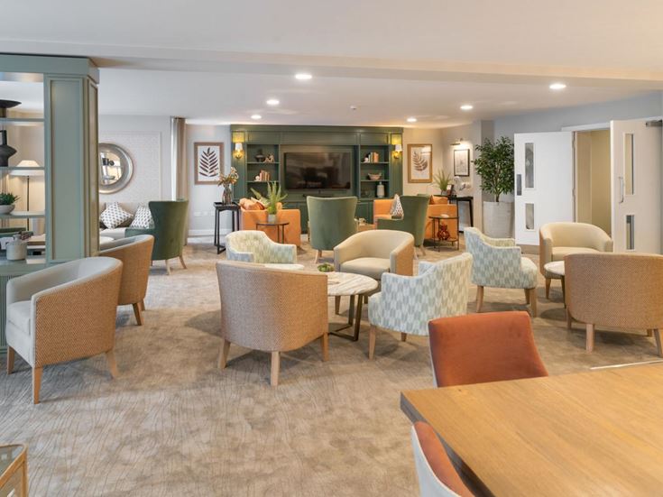 a room with a table chairs and a large mirror