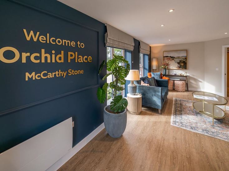 a room with a sign and a couch and a table