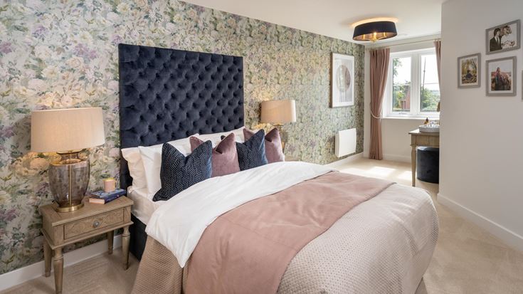 a bedroom with a bed and lamps