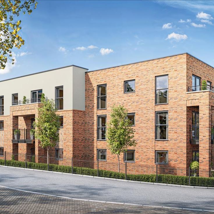 a brick building with trees and a fence around it
