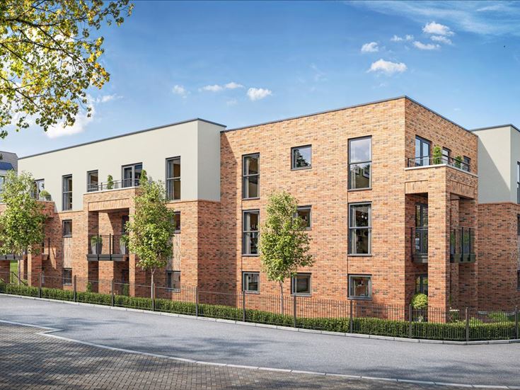 a brick building with trees and a fence around it