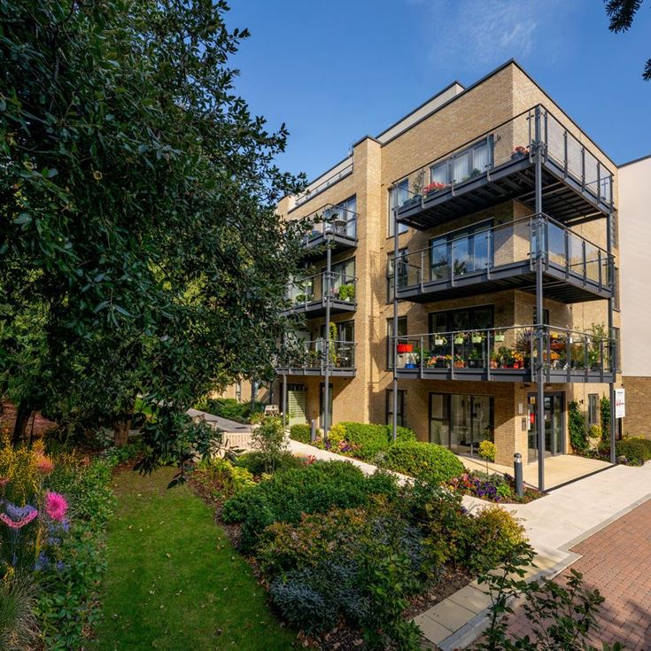 a building with a walkway and trees