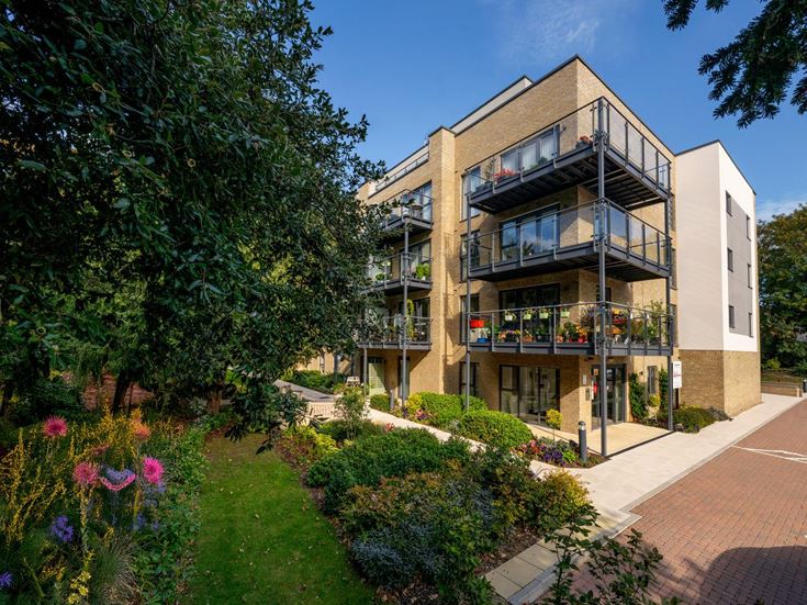 a building with a walkway and trees