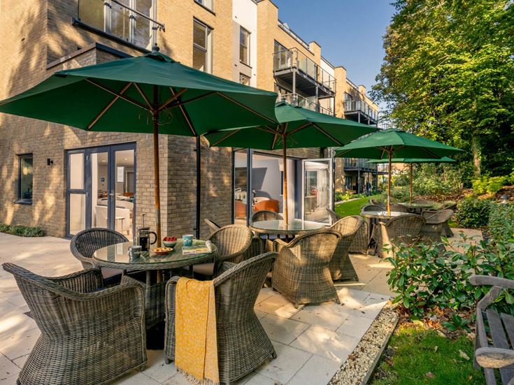 a patio with tables and chairs