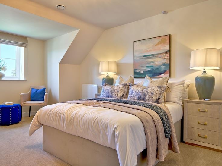a bedroom with a bed and lamps
