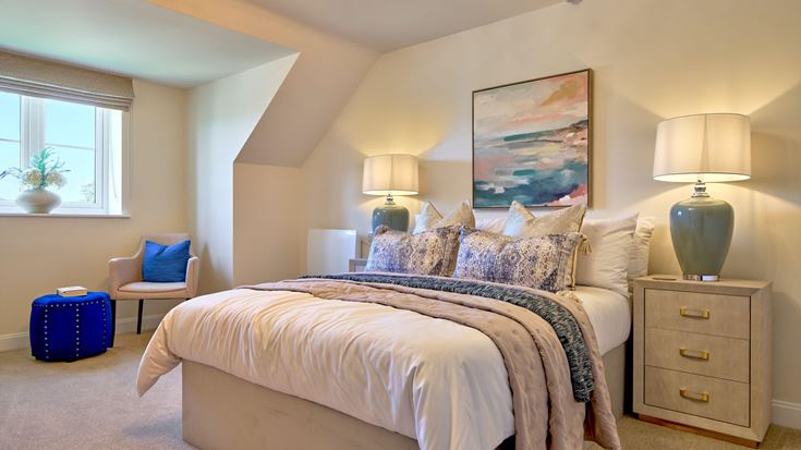 a bedroom with a bed and lamps