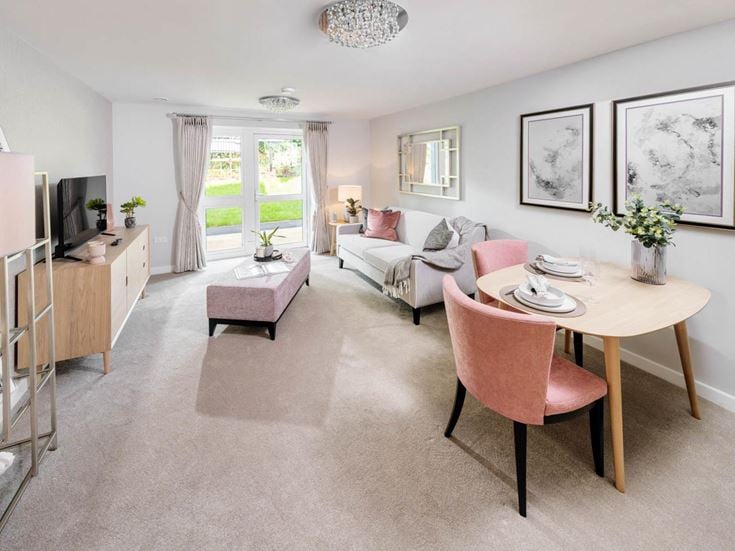 a living room with a table and chairs