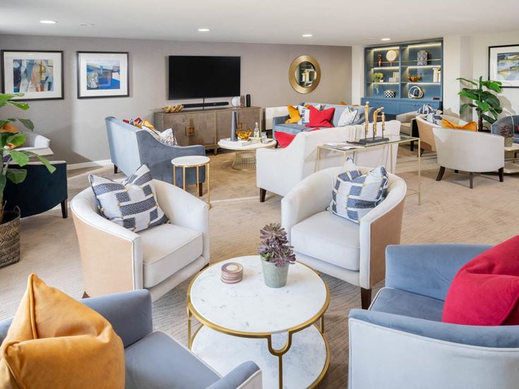 a living room with a large tv and couches