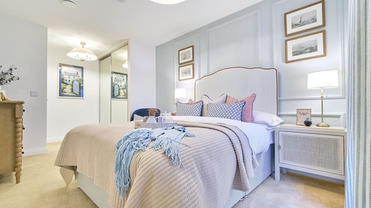 a bedroom with a bed and a lamp