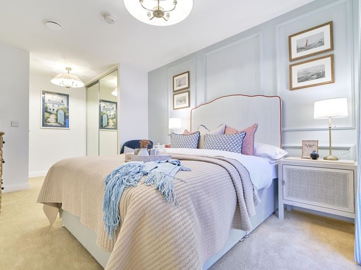 a bedroom with a bed and a lamp