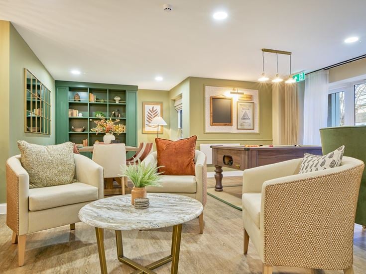 a living room with a couch and chairs