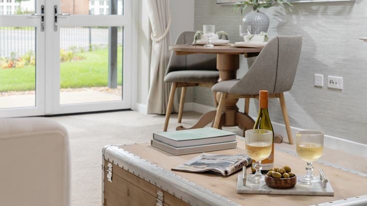 a table with a glass of wine and a bottle of wine